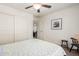 This bedroom features carpet floors, a ceiling fan, and a large closet, and lots of natural light at 20565 W Terrace Ln, Buckeye, AZ 85396