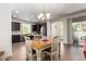 Elegant dining area featuring a charming chandelier, a stylish table, and an open layout to the kitchen at 20565 W Terrace Ln, Buckeye, AZ 85396