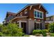 Inviting home exterior showcasing a quaint porch, well-maintained garden, and stylish architectural design at 20565 W Terrace Ln, Buckeye, AZ 85396