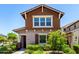 Charming home with brown shingle accents, lush landscaping, and inviting front entrance at 20565 W Terrace Ln, Buckeye, AZ 85396
