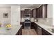Beautiful kitchen with dark cabinets, stainless appliances, granite counters, and modern backsplash at 20565 W Terrace Ln, Buckeye, AZ 85396