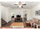 Spacious living room features stylish furniture, wood-look tile flooring, and ample natural light at 20565 W Terrace Ln, Buckeye, AZ 85396