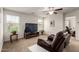 Bright living room featuring neutral colors, large TV, and comfortable seating for a relaxing atmosphere at 20565 W Terrace Ln, Buckeye, AZ 85396