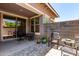 Charming covered patio with outdoor seating and patterned brick, perfect for relaxing and entertaining at 20565 W Terrace Ln, Buckeye, AZ 85396