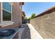 Side yard featuring a tidy walkway, stone landscaping, and easy access to the backyard at 20565 W Terrace Ln, Buckeye, AZ 85396
