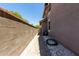 Side yard with low-maintenance desert landscaping and a paved walkway, connecting front to back at 20565 W Terrace Ln, Buckeye, AZ 85396