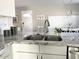 Well-lit kitchen with granite countertops, stainless steel sink, and modern fixtures at 2100 N Normal Ave, Tempe, AZ 85288