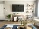 Inviting living room showcasing a large TV, decorative shelving, and comfortable seating at 2100 N Normal Ave, Tempe, AZ 85288