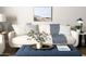 Comfortable living room with a tufted ottoman, plush cushions, and stylish decor at 2100 N Normal Ave, Tempe, AZ 85288