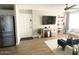 Spacious living room with a large TV, modern shelving, and comfortable seating area at 2100 N Normal Ave, Tempe, AZ 85288
