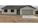 Inviting single-story home with a gray roof, a two-car garage and low maintenance landscaping at 22343 S Manzanilla Rd, Buckeye, AZ 85326