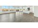 Bright, open-concept living space with hard surface floors and a kitchen featuring white cabinets at 22343 S Manzanilla Rd, Buckeye, AZ 85326