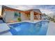 A beautiful backyard showcasing a private pool with waterfall features and cozy string lights for evening relaxation at 22515 E Sonoqui Blvd, Queen Creek, AZ 85142