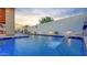 Stunning backyard pool area with a water feature, elegant patio furniture, and manicured landscaping at 22515 E Sonoqui Blvd, Queen Creek, AZ 85142
