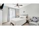 Bright bedroom with a comfortable bed, gray furnishings, and a large window at 22515 E Sonoqui Blvd, Queen Creek, AZ 85142
