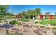 Beautiful community garden featuring planter boxes, walkways, and a bench for relaxing at 22515 E Sonoqui Blvd, Queen Creek, AZ 85142