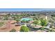 Aerial view of a community pool, showcasing well-maintained green spaces, a playground and mountain views at 22515 E Sonoqui Blvd, Queen Creek, AZ 85142