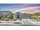 Charming single-story home with desert landscaping and a two-car garage beneath a colorful dusk sky at 22515 E Sonoqui Blvd, Queen Creek, AZ 85142
