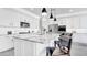 Bright white kitchen features an island with granite countertops and modern pendant lighting overhead at 22515 E Sonoqui Blvd, Queen Creek, AZ 85142