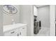 Clean laundry room with modern appliances, white cabinets, and a decorative sign at 22515 E Sonoqui Blvd, Queen Creek, AZ 85142