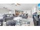 Spacious living room featuring contemporary furnishings and an open floor plan leading to the kitchen and dining areas at 22515 E Sonoqui Blvd, Queen Creek, AZ 85142
