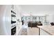 Open-concept design showcasing the kitchen with white cabinetry and a view into the stylishly decorated living room at 22515 E Sonoqui Blvd, Queen Creek, AZ 85142