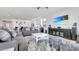 Comfortable living room with sleek decor, including an entertainment center and an open view of the modern kitchen at 22515 E Sonoqui Blvd, Queen Creek, AZ 85142