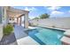 Inviting pool area with tanning ledge, covered patio, and ample space for outdoor enjoyment and lounging at 22515 E Sonoqui Blvd, Queen Creek, AZ 85142