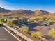 Community center showcasing desert landscaping, walking paths, parking, and mountain views providing recreation and beauty at 2361 N 212Th Dr, Buckeye, AZ 85396