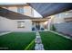 Backyard with grass, a stone pathway, and a covered outdoor living space at 2361 N 212Th Dr, Buckeye, AZ 85396