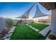 Landscaped backyard featuring rock pathways, grass, and mature landscaping at 2361 N 212Th Dr, Buckeye, AZ 85396