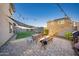 Large backyard features a covered patio, dining, and manicured landscaping at 2361 N 212Th Dr, Buckeye, AZ 85396