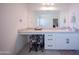 Bathroom features a vanity with white cabinets, countertop space, and tiled flooring at 2361 N 212Th Dr, Buckeye, AZ 85396