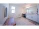 Bright bathroom with vanity, white cabinets, and a spacious countertop at 2361 N 212Th Dr, Buckeye, AZ 85396