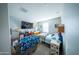 Cozy bedroom features a television, ceiling fan, and comfortable bed at 2361 N 212Th Dr, Buckeye, AZ 85396
