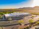 A large building with a full parking lot, desert landscaping and neighborhood in the background at 2361 N 212Th Dr, Buckeye, AZ 85396