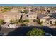Beautiful two-story home with a well-manicured front yard, long driveway, and a charming exterior, with mountain views at 2361 N 212Th Dr, Buckeye, AZ 85396