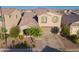 Charming two-story home with a well-maintained lawn, mature trees, and a welcoming driveway leading to a two-car garage at 2361 N 212Th Dr, Buckeye, AZ 85396