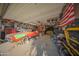 Organized garage featuring classic cars, wall decorations, ample shelving, and storage; the ultimate workspace for automotive enthusiasts at 2361 N 212Th Dr, Buckeye, AZ 85396