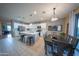 Bright kitchen featuring white cabinets, a quartz countertop island, and an adjacent dining table at 2361 N 212Th Dr, Buckeye, AZ 85396