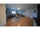 Spacious living room features a comfortable gray sectional, hardwood floors, and stylish decor at 2361 N 212Th Dr, Buckeye, AZ 85396