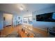 Open-concept living space with hardwood floors connecting the living room to the modern kitchen at 2361 N 212Th Dr, Buckeye, AZ 85396