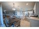 Open concept living space with an adjacent dining area and modern kitchen island at 2361 N 212Th Dr, Buckeye, AZ 85396
