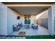 Cozy covered patio with seating, TV, and sliding glass door access to the home's interior, perfect for outdoor relaxation at 2361 N 212Th Dr, Buckeye, AZ 85396