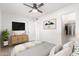 Comfortable bedroom with en suite bathroom, natural light, and a ceiling fan at 2508 N 58Th Ln, Phoenix, AZ 85035