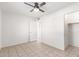 Vacant bedroom with en suite bathroom, natural light, and a ceiling fan at 2508 N 58Th Ln, Phoenix, AZ 85035