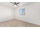 Clean, vacant bedroom with neutral tones, natural light, and tile flooring at 2508 N 58Th Ln, Phoenix, AZ 85035