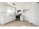 Bright kitchen featuring white cabinetry, stainless steel oven, and tile flooring at 2508 N 58Th Ln, Phoenix, AZ 85035