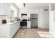 Modern kitchen with stainless steel appliances, white cabinets, tile floors, and ample counter space at 2508 N 58Th Ln, Phoenix, AZ 85035