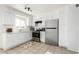 Bright kitchen featuring white cabinetry, stainless steel appliances, and tile flooring at 2508 N 58Th Ln, Phoenix, AZ 85035
